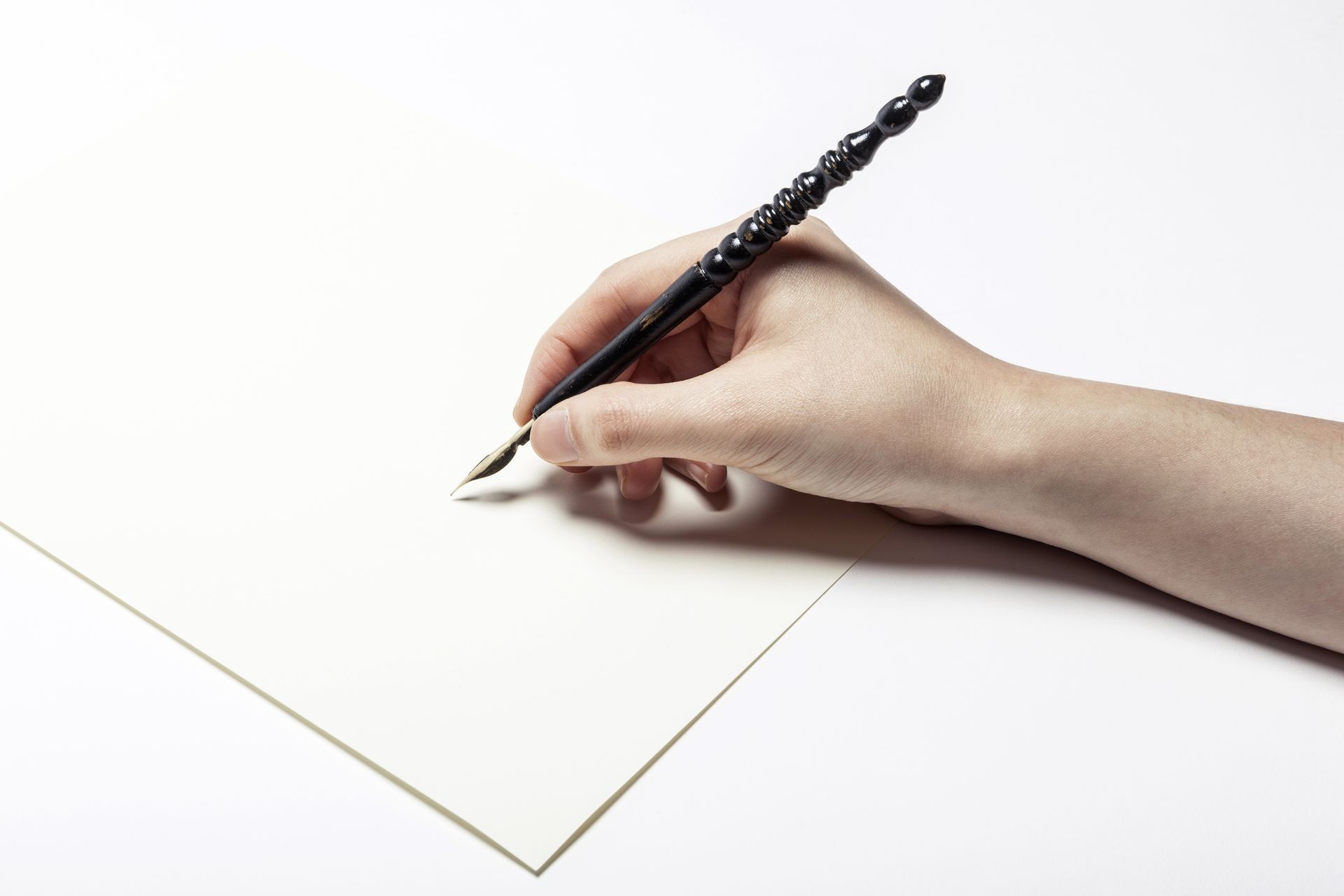 A female(woman) hand hold(write) a fountain pen and letter and ink isolated white at the studio.